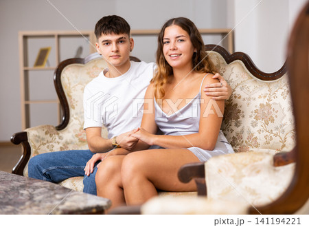 Portrait of loving family couple sitting in comfy home room 141194221