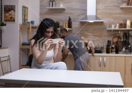 Desperate woman holds a bag with drug powder at home, showing drug addiction, unhealthy dependence and a dangerous personal crisis. Desperate woman holds a bag with drug powder at home, showing drug addiction, unhealthy dependence and a dangerous personal crisis. 141194497