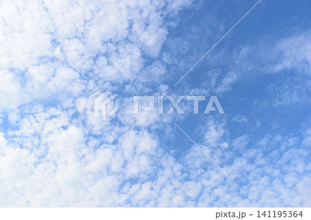 beautiful blue sky and white fluffy group of clouds with sunrise in the morning, natural background beautiful blue sky and white fluffy group of clouds with sunrise in the morning, natural background 141195364