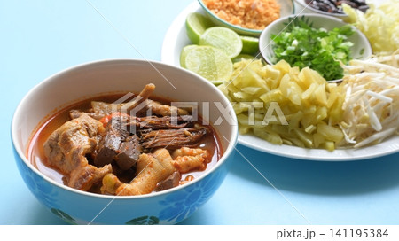 rice vermicelli with northern thai curry sauce on blue background 141195384