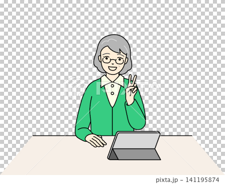 A senior woman smiles and makes a peace sign in front of a tablet. A senior woman smiles and makes a peace sign in front of a tablet. 141195874
