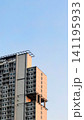 a modern high-rise apartment building set against a clear blue sky, representing contemporary urban living and residential architecture. This image is ideal for real estate marketing, property investm 141195933