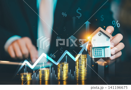 Businessman holding home model with growing stacks of gold coins, financial growth chart arrow, percentage icons for real estate investment. Businessman holding home model with growing stacks of gold coins, financial growth chart arrow, percentage icons for real estate investment. 141196675