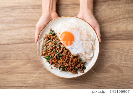 Thai food, Stir-fried holy basil with minced pork with cooked rice and fried egg Thai food, Stir-fried holy basil with minced pork with cooked rice and fried egg 141196907