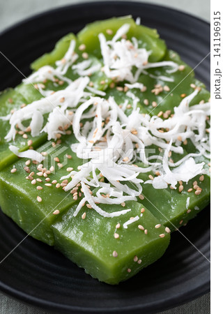 Traditional Thai dessert, pandan sweet pudding topped with coconut and toasted sesame seeds Traditional Thai dessert, pandan sweet pudding topped with coconut and toasted sesame seeds 141196915