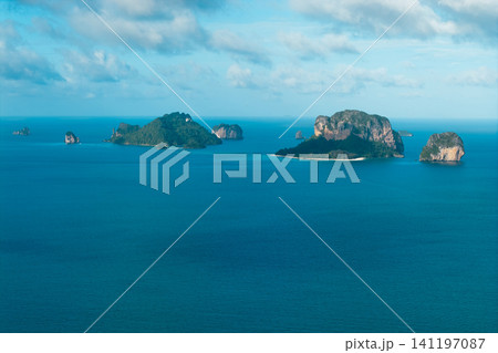 Stunning aerial view of exotic limestone karst islands scattered across the clear blue waters of the Andaman Sea in Krabi, Thailand. Stunning aerial view of exotic limestone karst islands scattered across the clear blue waters of the Andaman Sea in Krabi, Thailand. 141197087