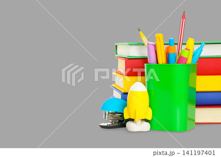 Bright stationery and stacked books ready for students to use Bright stationery and stacked books ready for students to use 141197401