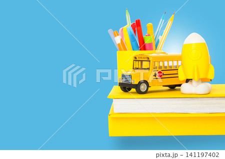Colorful supplies and a yellow bus signify the start of school Colorful supplies and a yellow bus signify the start of school 141197402
