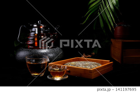 Traditional Chinese tea ceremony with pu erh tea cake and glass teapot 141197695