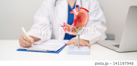 Doctor with Gastric anatomy model. Gastroenterologist consultation, stomach diseases and ulcers, November stomach cancer, Gastroesophageal Reflux Disease, GERD, Acid reflux and healthcare medical Doctor with Gastric anatomy model. Gastroenterologist consultation, stomach diseases and ulcers, November stomach cancer, Gastroesophageal Reflux Disease, GERD, Acid reflux and healthcare medical 141197948
