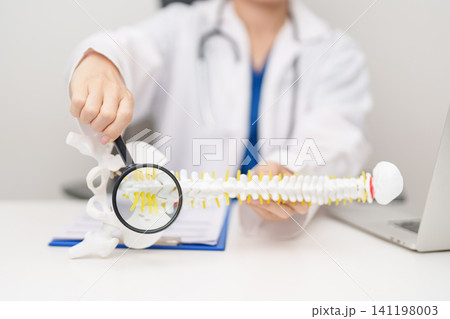Doctor with human Spine anatomy model. Spinal Cord Disorder and disease, Back pain, Lumbar, Sacral pelvis, Cervical neck, Thoracic, Coccyx, Orthopedist, chiropractic, Office Syndrome and health Doctor with human Spine anatomy model. Spinal Cord Disorder and disease, Back pain, Lumbar, Sacral pelvis, Cervical neck, Thoracic, Coccyx, Orthopedist, chiropractic, Office Syndrome and health 141198003