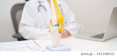 Doctor with Human Knee joint anatomy model. Osteoarthritis, Patellofemoral Pain Syndrome, Patellar Tendinitis, ACL, Anterior Cruciate Ligament, PCL, Posterior, MCL, Medial Collateral, LCL and Lateral Doctor with Human Knee joint anatomy model. Osteoarthritis, Patellofemoral Pain Syndrome, Patellar Tendinitis, ACL, Anterior Cruciate Ligament, PCL, Posterior, MCL, Medial Collateral, LCL and Lateral 141198019