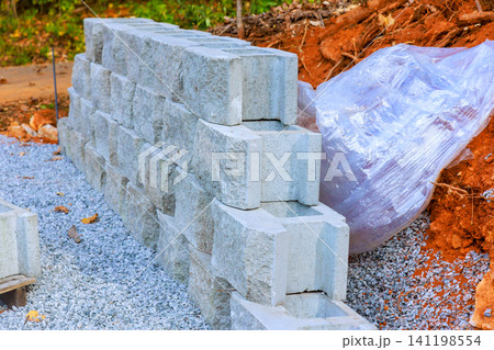 Construction site stacked concrete blocks during assemble retaining wall Construction site stacked concrete blocks during assemble retaining wall 141198554