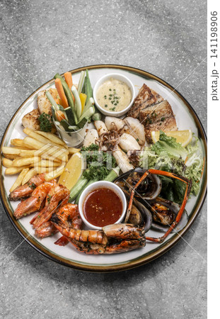 mixed mediterranean fish and seafood assortment plate on spanish restaurant table mixed mediterranean fish and seafood assortment plate on spanish restaurant table 141198906