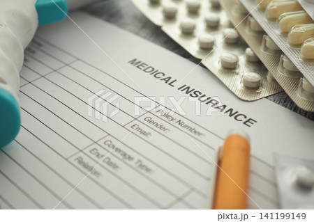 Filling out a medical insurance form at home Filling out a medical insurance form at home 141199149