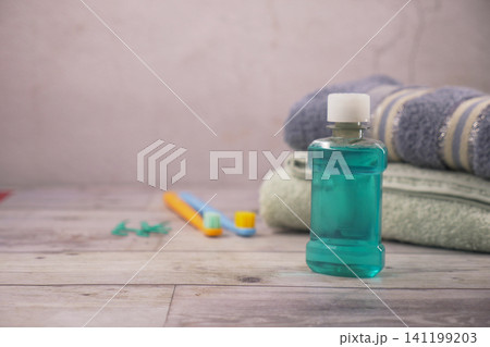 Mint mouthwash, towels, and toothbrushes on counter Mint mouthwash, towels, and toothbrushes on counter 141199203