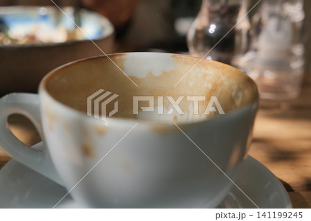 Coffee cup sits empty after a morning drink Coffee cup sits empty after a morning drink 141199245