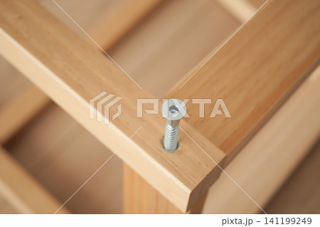 Wood frame assembly with visible screw detail during work Wood frame assembly with visible screw detail during work 141199249