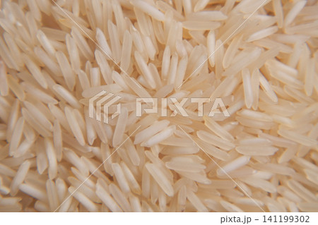 Rice grains scattered on a flat surface Rice grains scattered on a flat surface 141199302