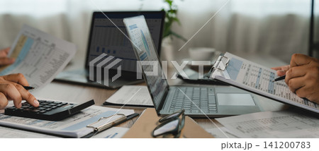business planning financial documents laptops on an office desk, using spreadsheets and reports for business planning, data analysis, and investment reporting workflow. 141200783