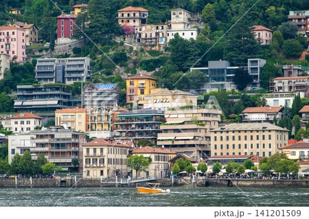 Old houses building architecture on lake Como, Italy. Italian village Cityscape with Colorful houses on a Green Hill Old houses building architecture on lake Como, Italy. Italian village Cityscape with Colorful houses on a Green Hill 141201509