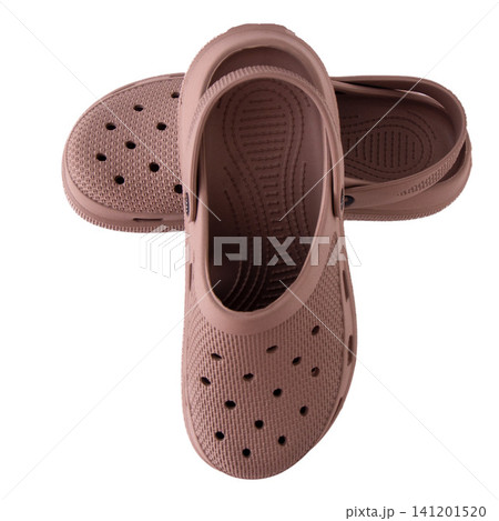 Pair of dusty rose rubber clogs isolated on white background Pair of dusty rose rubber clogs isolated on white background 141201520