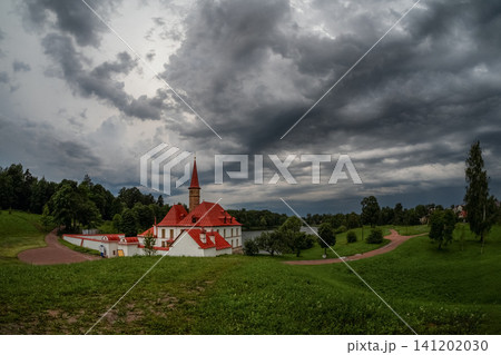 Priory Palace in Gatchina, Russia, under a dramatic stormy sky with dark heavy clouds. 141202030