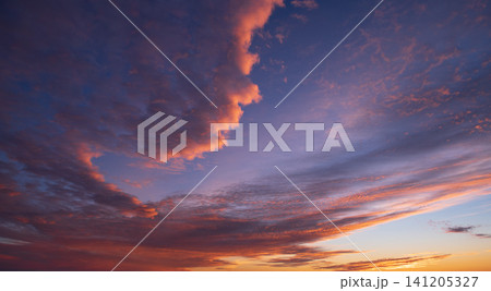 Beautiful colorful dramatic cloud formation in purple sky during peaceful sunset over natural landscape of utah usa creating deeply serene and awe inspiring atmosphere of orange light Beautiful colorful dramatic cloud formation in purple sky during peaceful sunset over natural landscape of utah usa creating deeply serene and awe inspiring atmosphere of orange light 141205327