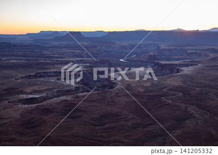 Peaceful majestic sunrise illuminates vast desert canyon valley landscape located in utah usa with stunning geological rock formation creating serene natural outdoor scenery for exploration Peaceful majestic sunrise illuminates vast desert canyon valley landscape located in utah usa with stunning geological rock formation creating serene natural outdoor scenery for exploration 141205332