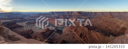 Majestic breathtaking canyon landscape features deep valley winding river red rock formations under vast bright sky creating awe inspiring scenic view across dry desert terrain of utah usa 141205333