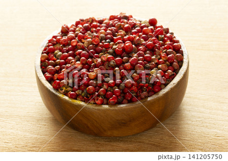 red pepper seeds in wooden plate red pepper seeds in wooden plate 141205750