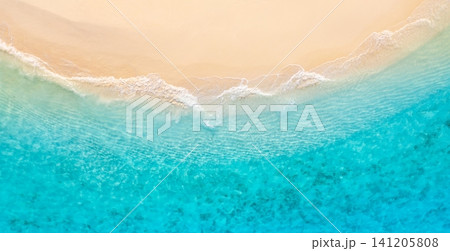 Top down aerial of curving wave edge between bright turquoise sea and smooth sand. Organic foam curve crossing tropical shoreline, graphic natural composition from above. Versatile drone background Top down aerial of curving wave edge between bright turquoise sea and smooth sand. Organic foam curve crossing tropical shoreline, graphic natural composition from above. Versatile drone background 141205808
