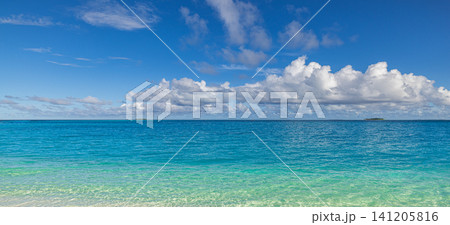 Open turquoise sea meeting deep blue horizon under white summer clouds. Gradient of clear shallow water to dark ocean, minimal tropical seascape in daylight. Clean natural background for travel Open turquoise sea meeting deep blue horizon under white summer clouds. Gradient of clear shallow water to dark ocean, minimal tropical seascape in daylight. Clean natural background for travel 141205816