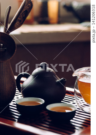 Teapot and cups with Chinese tea on the table for the tea ceremony Teapot and cups with Chinese tea on the table for the tea ceremony 141206318