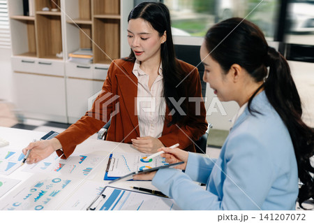 Businessmen team or financial data analysts working with tablets and laptop computers and data graphs together. Plan to analyzing projects in the office. Businessmen team or financial data analysts working with tablets and laptop computers and data graphs together. Plan to analyzing projects in the office. 141207072