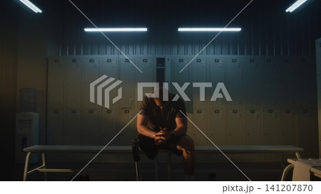 Amputee Athlete Mentally Preparing for Training in Modern Locker Room Amputee Athlete Mentally Preparing for Training in Modern Locker Room 141207870