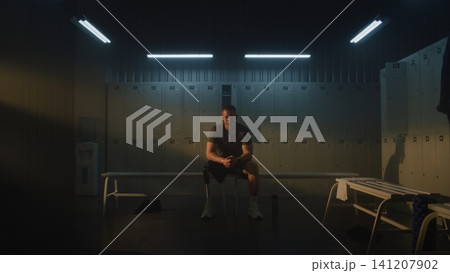 Amputee Athlete Mentally Preparing for Training in Modern Locker Room Amputee Athlete Mentally Preparing for Training in Modern Locker Room 141207902