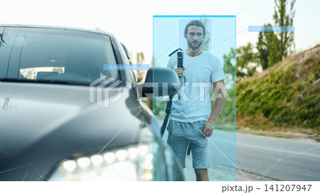 Man stands near car with firearm while facial recognition and surveillance are active 141207947