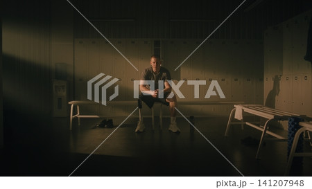 Resilient Man with Physical Disability Reflecting in Locker Room Resilient Man with Physical Disability Reflecting in Locker Room 141207948