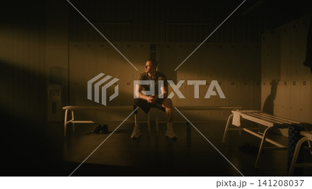 Determined Male Athlete with Prosthetic Leg Practicing Mindfulness Before Training Determined Male Athlete with Prosthetic Leg Practicing Mindfulness Before Training 141208037