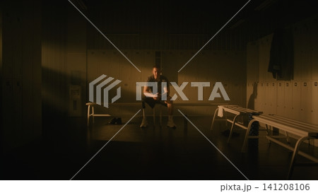 Determined Male Athlete with Prosthetic Leg Practicing Mindfulness Before Training Determined Male Athlete with Prosthetic Leg Practicing Mindfulness Before Training 141208106