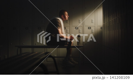 Exhausted Amputee Athlete Recovering in Locker Room After Training Session Exhausted Amputee Athlete Recovering in Locker Room After Training Session 141208109