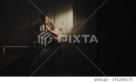 Young Man with Prosthetic Leg Leaning Back Against Lockers Young Man with Prosthetic Leg Leaning Back Against Lockers 141208175