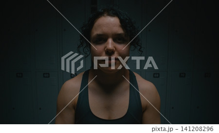 Tired But Satisfied Female Sits on Bench after Intense Workout 141208296