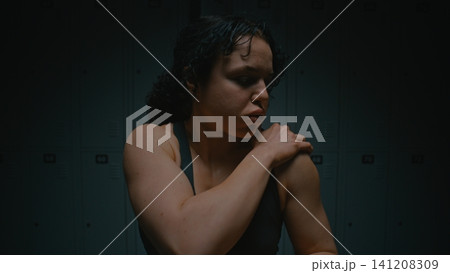 Determined Female Athlete Shaking Off Tension and Mentally Preparing for Competition Determined Female Athlete Shaking Off Tension and Mentally Preparing for Competition 141208309