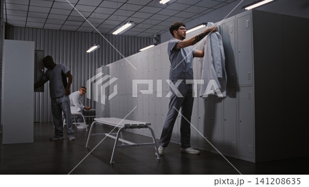 Diverse Group of Doctors Changing Clothes in Hospital Locker Room After Long Medical Shift Diverse Group of Doctors Changing Clothes in Hospital Locker Room After Long Medical Shift 141208635