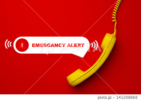 Emergency service response alert with yellow phone on red background during a crisis situation Emergency service response alert with yellow phone on red background during a crisis situation 141208668