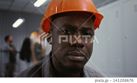 Intense Portrait of Factory Worker Looking Intently at Camera Intense Portrait of Factory Worker Looking Intently at Camera 141208676