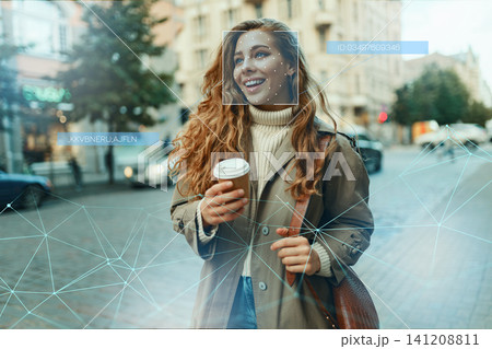 Facial recognition technology in use on a person in a city street during daytime 141208811