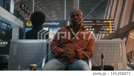 Traveler Scanning Digital Boarding Pass and Drinking Coffee Traveler Scanning Digital Boarding Pass and Drinking Coffee 141208871